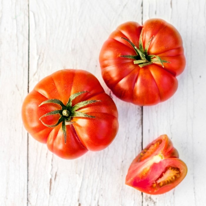 Almanac Planting Tomato Collection. Images of Brandywine Tomatoes (one sliced open into a wedge).