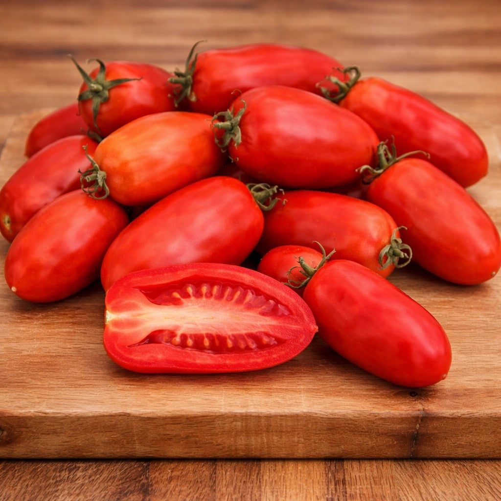 Almanac Planting Co: Fresh San Marzano tomatoes on cutting board showing elongated shape and dense red flesh