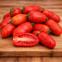 Almanac Planting Co: Fresh San Marzano tomatoes on cutting board showing elongated shape and dense red flesh