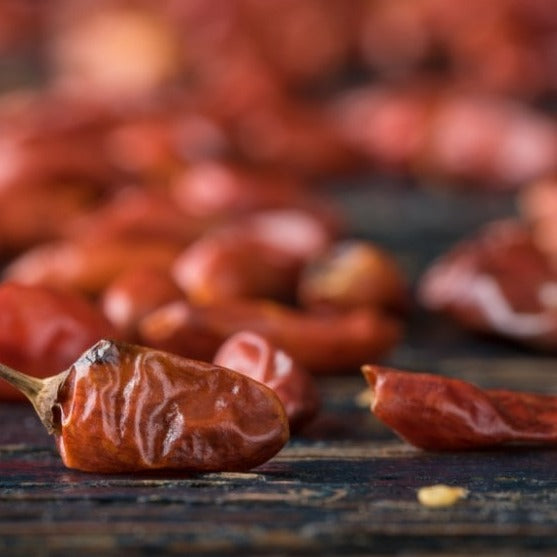 Almanac Planting Co Pequin Chili Pepper Plants. Dried peppers on a table.