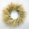 A hand-made fresh wreath made with blonde wheat, pearly everlasting, flax, and eryngium.