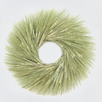 A handmade fresh wreath made with green wheat.