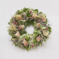 The Limelight Salal Wreath. Made with: air dried salal, artemisia, lupidium field pennycress, feather reed grass, coral globe amaranth, pink globe amaranth, lemon mint, ammobium, and limelight hydrangea. (zoomed out view)