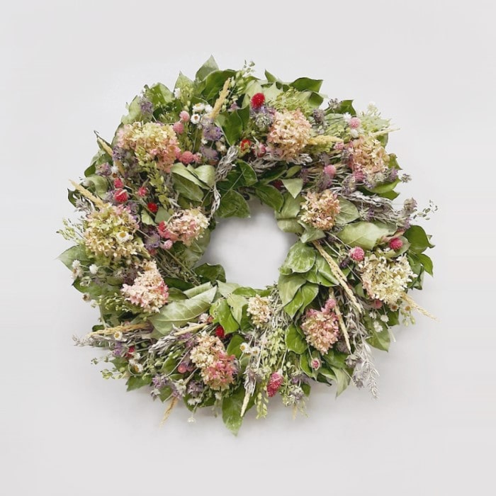 The Limelight Salal Wreath. Made with: air dried salal, artemisia, lupidium field pennycress, feather reed grass, coral globe amaranth, pink globe amaranth, lemon mint, ammobium, and limelight hydrangea. (zoomed out view)
