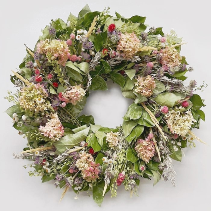 The Limelight Salal Wreath. Made with: air dried salal, artemisia, lupidium field pennycress, feather reed grass, coral globe amaranth, pink globe amaranth, lemon mint, ammobium, and limelight hydrangea. (zoomed in view)