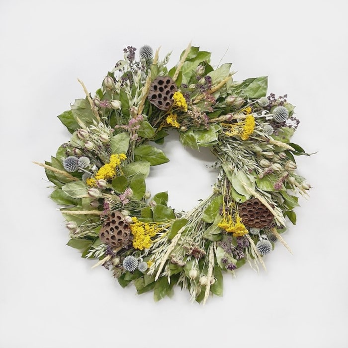 The Lotus Reed Wreath. Handmade with: air dried salal, avena oats, oregano, echinops, feather reed grass, natural color yarrow, yellow yarrow, nigella, and lotus pods. (A zoomed out image)