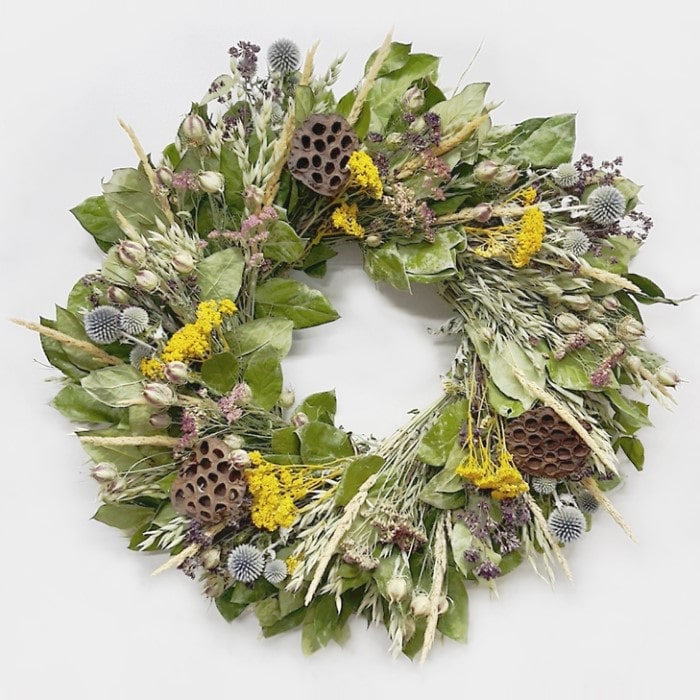 The Lotus Reed Wreath. Handmade with: air dried salal, avena oats, oregano, echinops, feather reed grass, natural color yarrow, yellow yarrow, nigella, and lotus pods. (A zoomed in image)