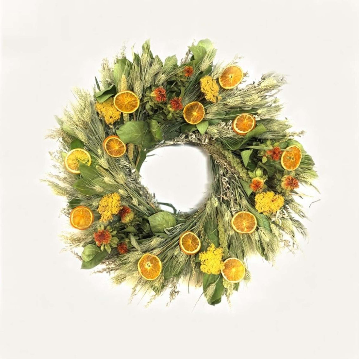 A fresh handmade wreath that's made with air dried salal, green wheat, artemisia, yarrow, China millet, Safflower, prosso millet, and orange slices.