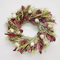 A handmade-to-order fresh wreath of avena oats, preserved burgundy salal, lupidium field pennycress, feather reed grass, poppy pods.