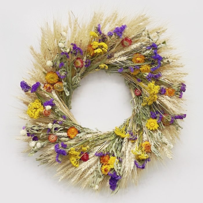 The Strawflower Amaranth Wreath. Made with: blonde wheat, sinuata statice, yarrow, ivory globe amaranth, and strawflowers. (zoomed in view)