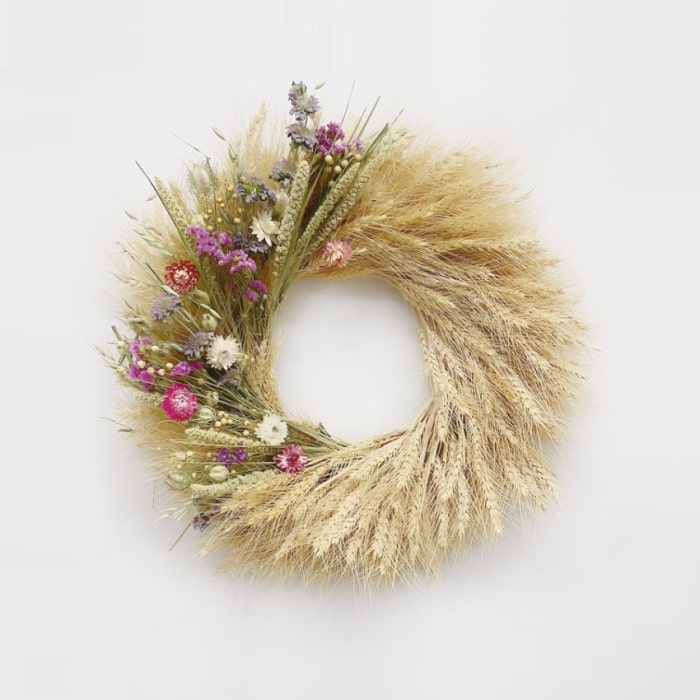 The Strawflower Blonde Wreath. Handmade with: blonde wheat, lemon mint, millet, flax, nigella, sinuata statice, and strawflowers. (A zoomed out image)