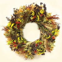The Yellow Oregano Wreath constructed with blonde wheat, broom corn, oregano, yellow sinuata statice, red globe amaranth, and yellow safflower.